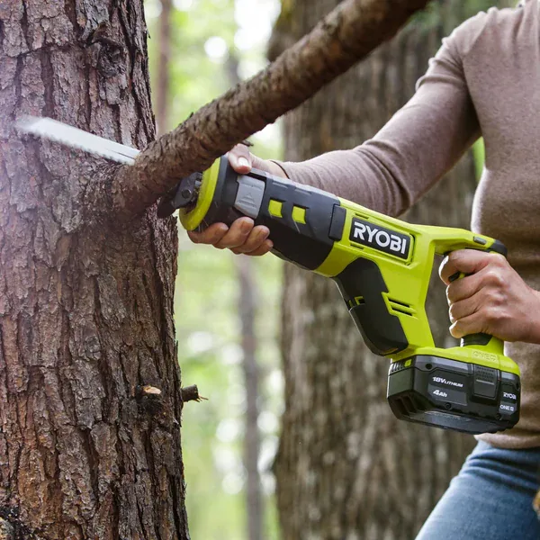 Reciprocating saw cutting a branch